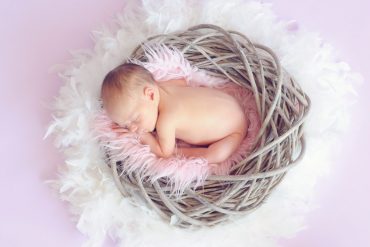 baby sleeping in a basket