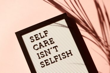 self-care wellness pink flatlay mental health
